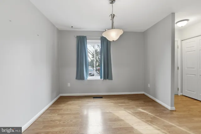 an empty room with a empty space and a window