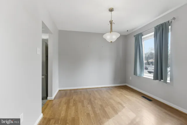 a view of a room with a chandelier fan and windows