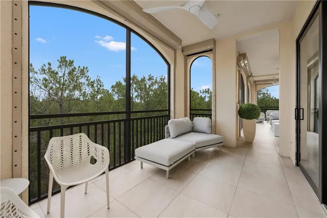 a balcony with furniture and a potted plant