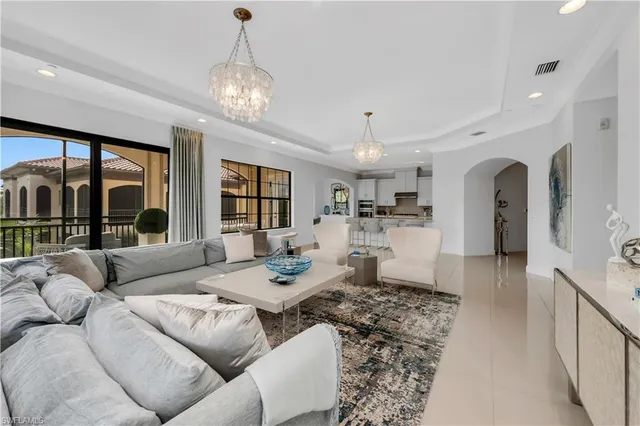 a living room with furniture and a chandelier