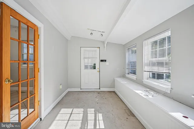 a view of a bedroom with furniture and windows