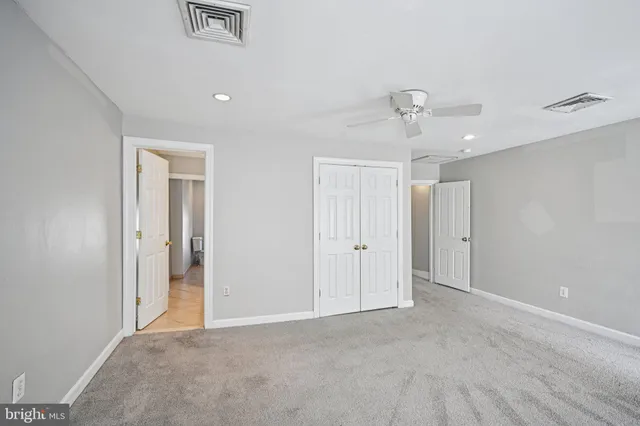 a view of an empty room and a ceiling fan window