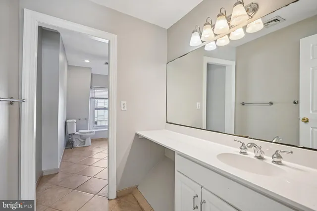 a spacious bathroom with a double vanity sink and a mirror