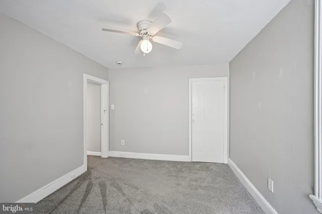 a view of an empty room with a fan