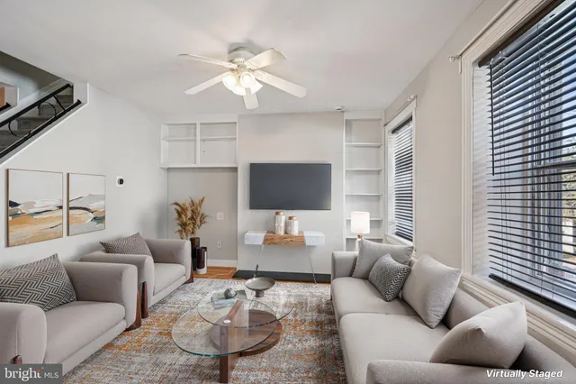 a living room with furniture a rug and a window