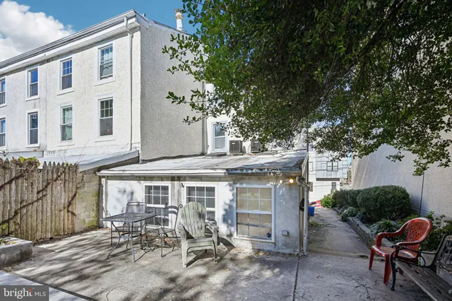 a building outdoor space with patio furniture and potted plants