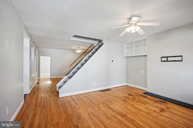 a view of empty room with wooden floor
