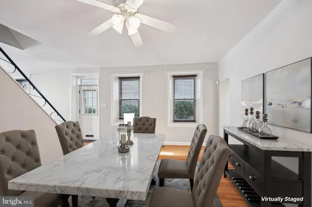 a dining room with furniture a chandelier and wooden floor