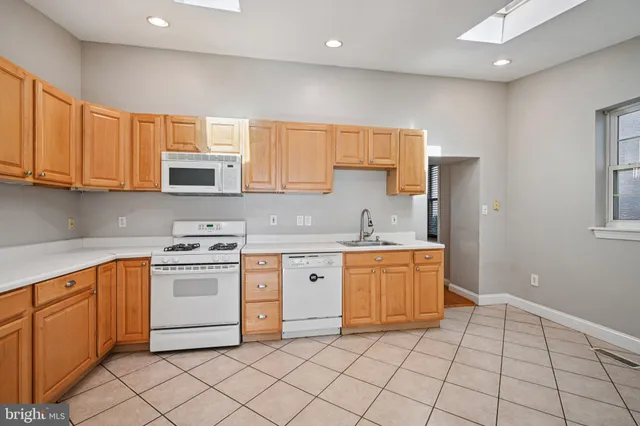 a kitchen with stainless steel appliances granite countertop a sink and cabinets