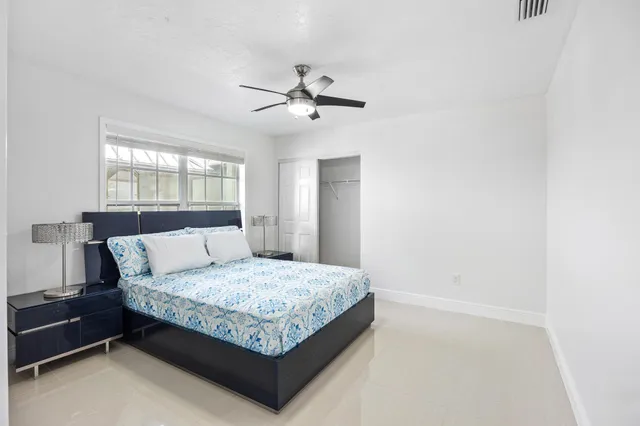 a spacious bathroom with a granite countertop sink a toilet and shower
