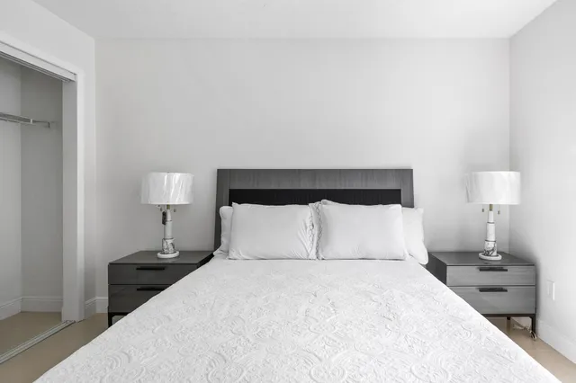 a bedroom with a bed and window