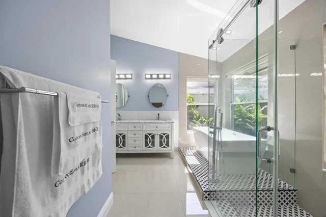 a kitchen with stainless steel appliances granite countertop white cabinets a stove and a sink