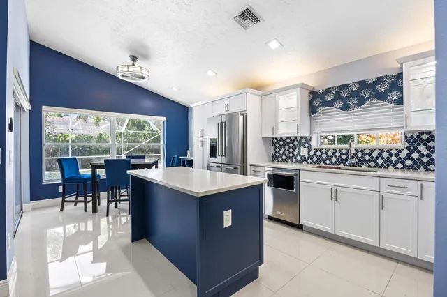 a kitchen with stainless steel appliances a refrigerator sink and cabinets