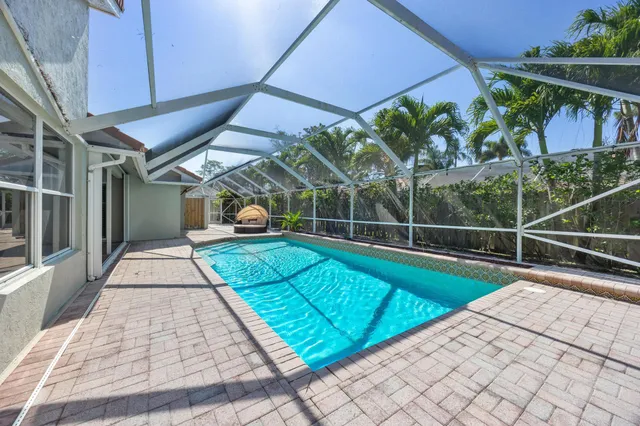 a view of a backyard with a fountain plants and large tree