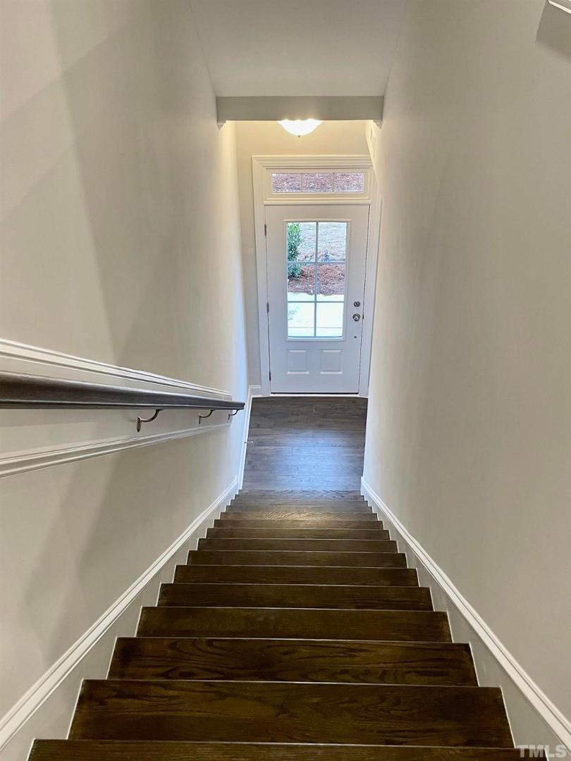8425 Garnet Rose Drive Raleigh, NC 27615 - Photo 5 of 11 a view of entryway and hall with wooden floor