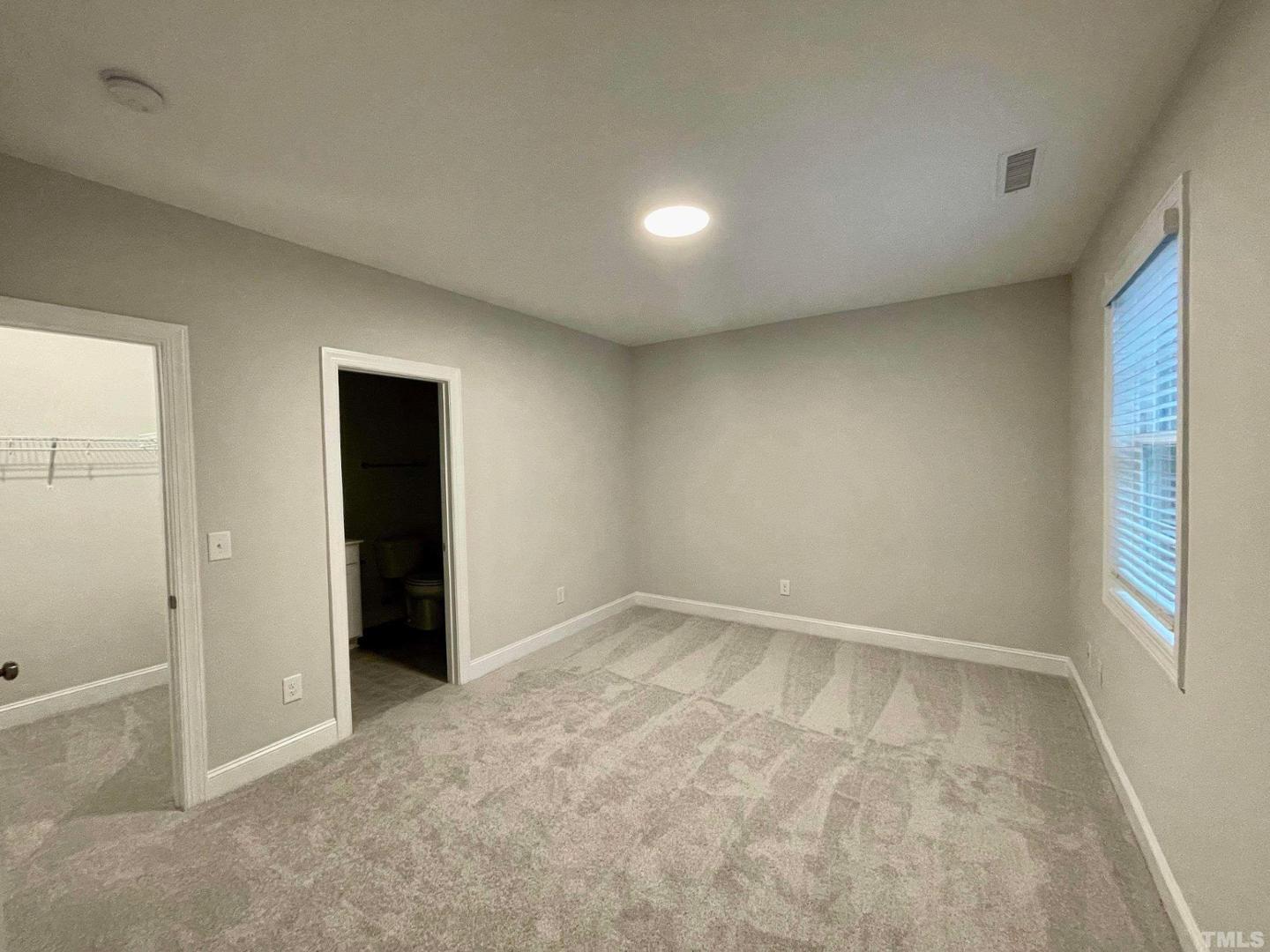 8425 Garnet Rose Drive Raleigh, NC 27615 - Photo 6 of 11 an empty room with windows