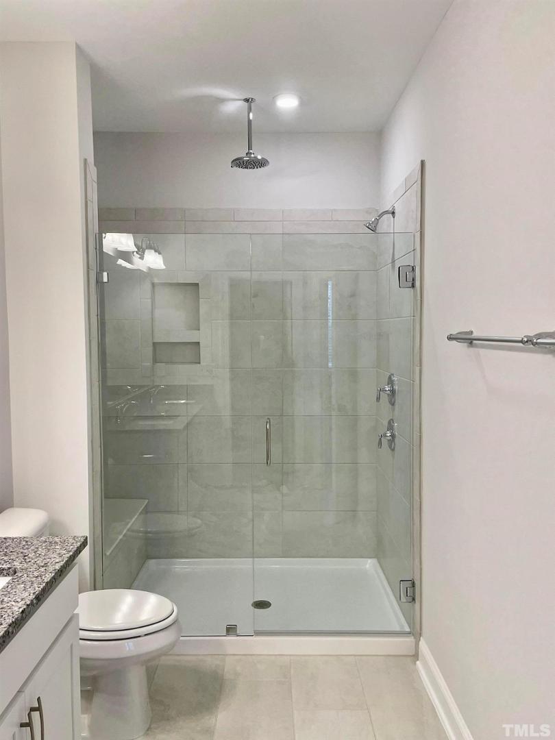 8425 Garnet Rose Drive Raleigh, NC 27615 - Photo 7 of 11 a bathroom with a shower a toilet and sink