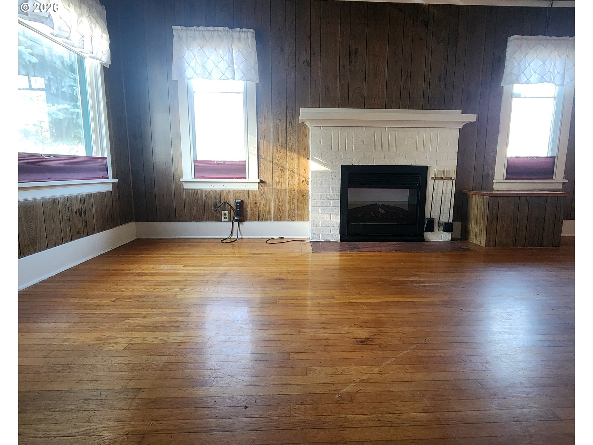 2605 Northeast Jarrett Street Portland, OR 97211 - Photo 14 of 23 a view of empty room with wooden floor and fireplace