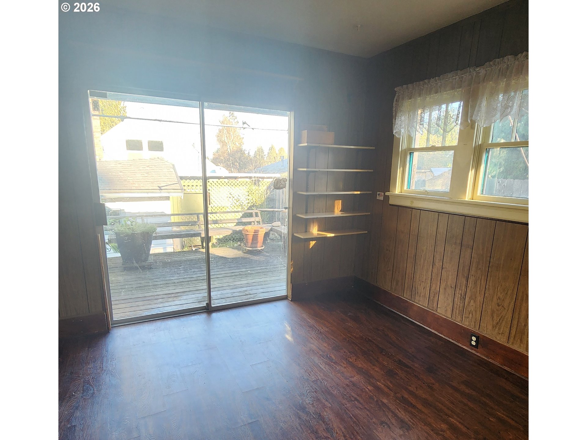 2605 Northeast Jarrett Street Portland, OR 97211 - Photo 5 of 23 an empty room with wooden floor and windows