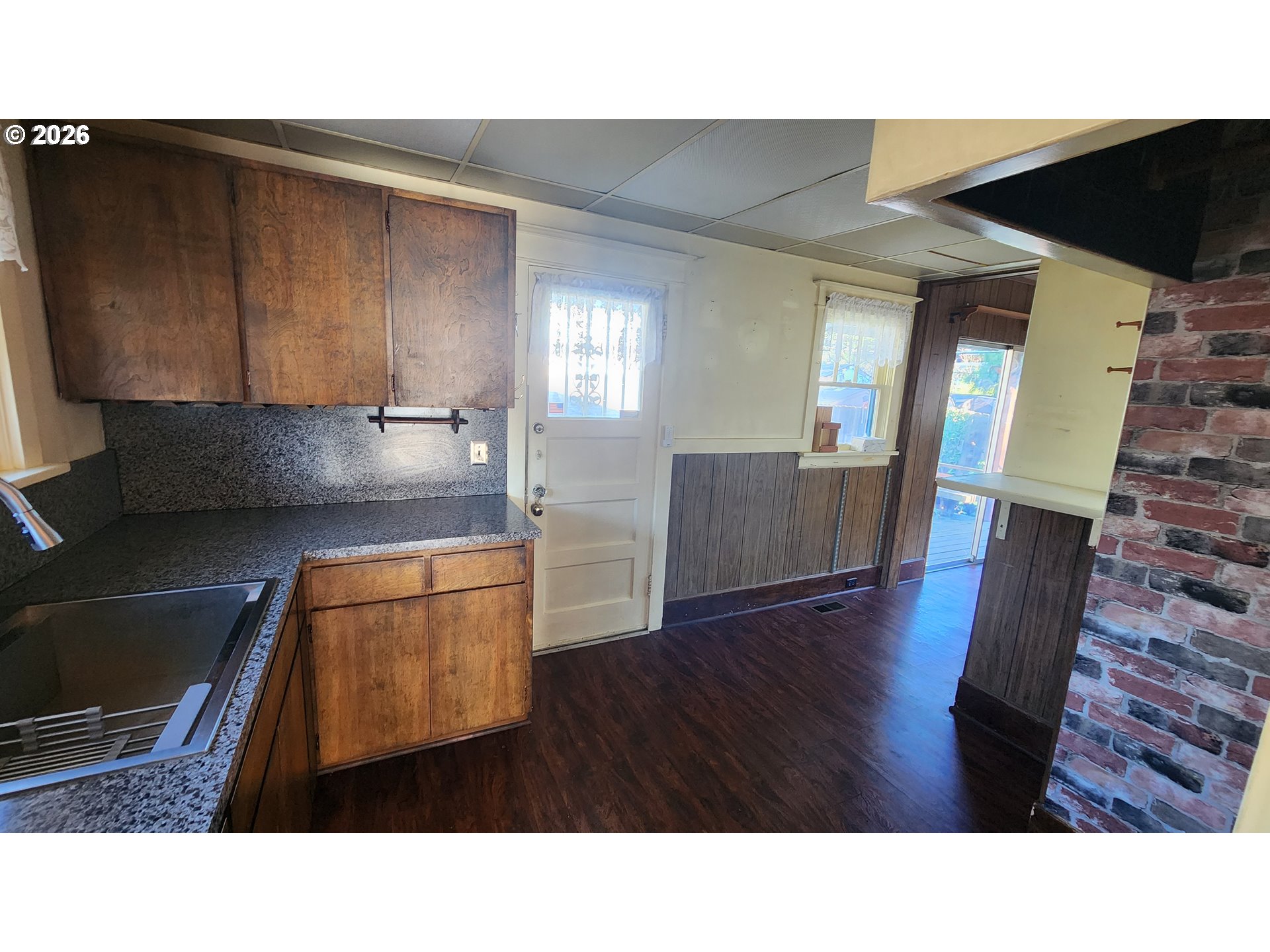 2605 Northeast Jarrett Street Portland, OR 97211 - Photo 7 of 23 a open kitchen with cabinets and wooden floor
