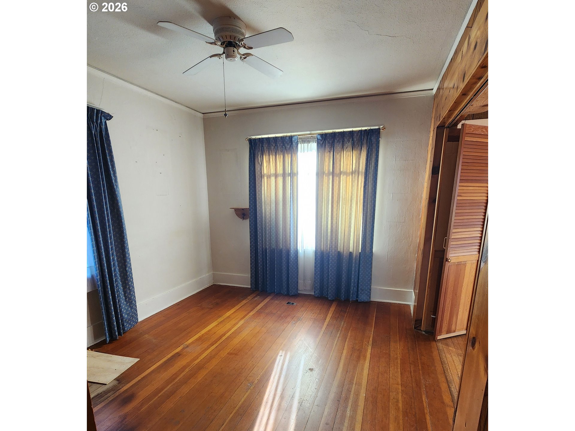 2605 Northeast Jarrett Street Portland, OR 97211 - Photo 9 of 23 an empty room with wooden floor and windows