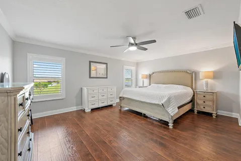 a bedroom with a bed a chandelier and a window