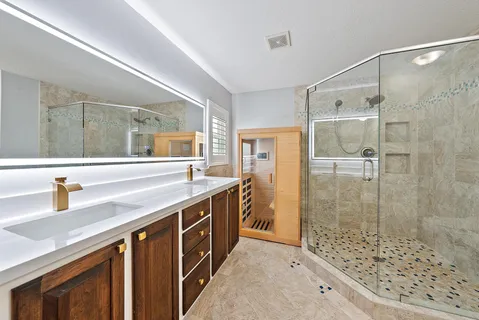 a bathroom with a shower sink and mirror