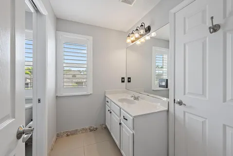 a bathroom with a double vanity sink and a mirror