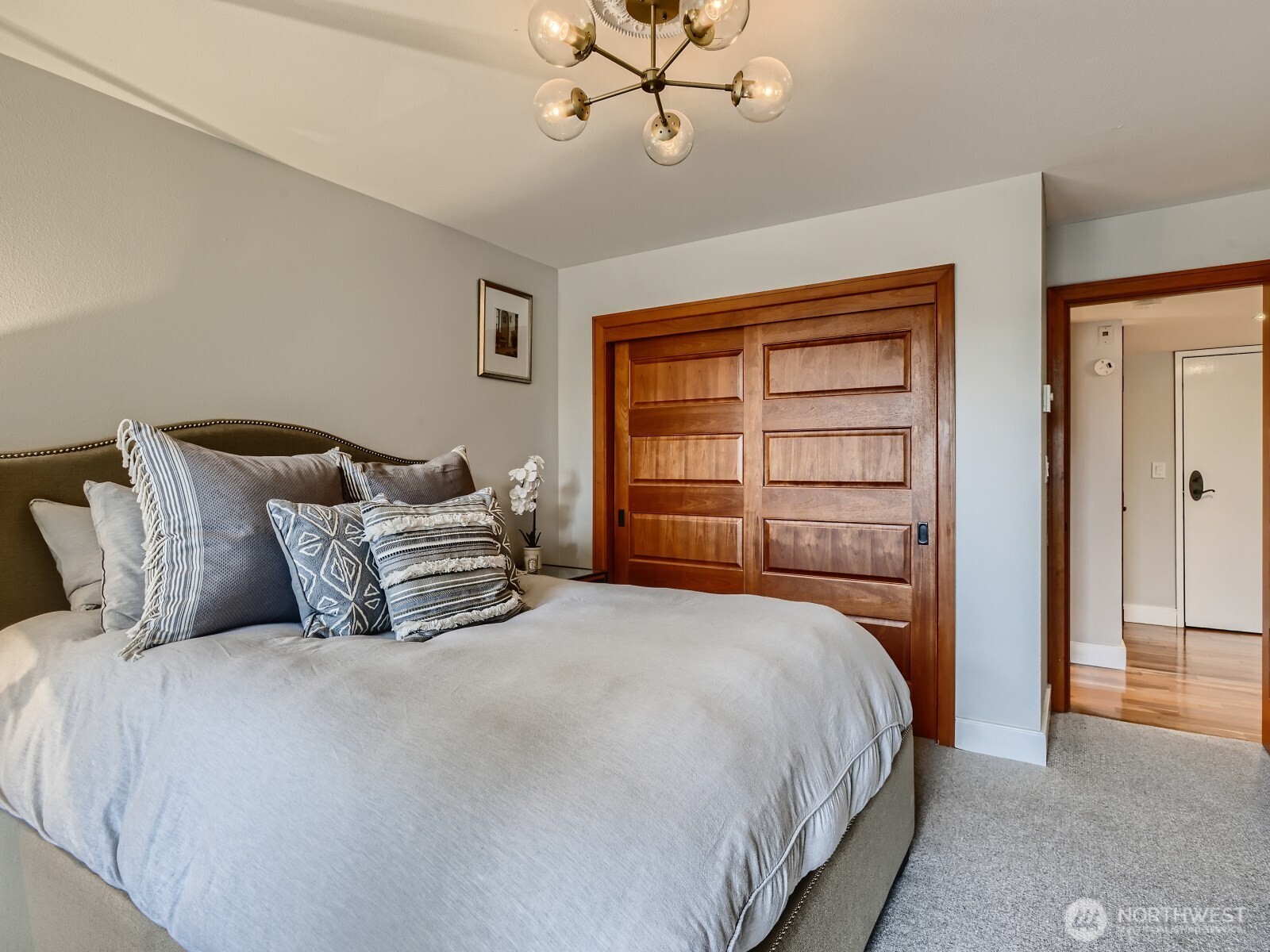 201 Galer Street, Unit 163 Seattle, WA 98109 - Photo 11 of 26 a bedroom with a bed and a chandelier