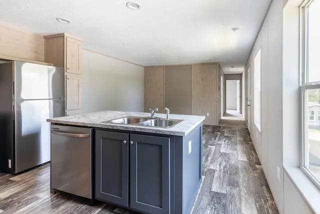 a kitchen with a sink and refrigerator