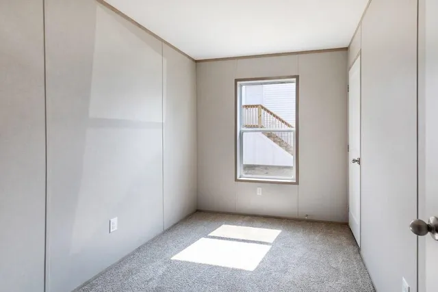 an empty room with windows and closet
