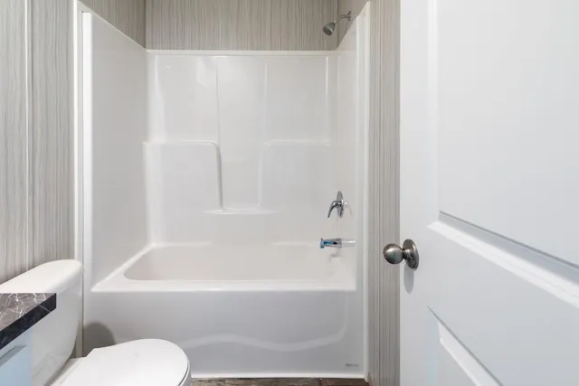 a bathroom with a toilet and a bathtub