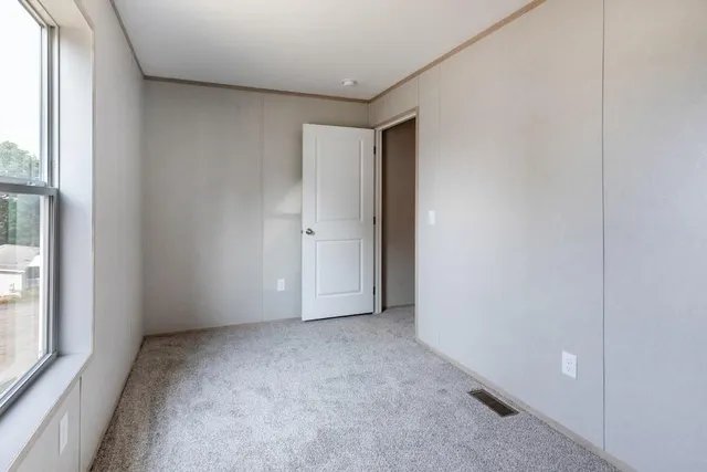 a view of an empty room and a window