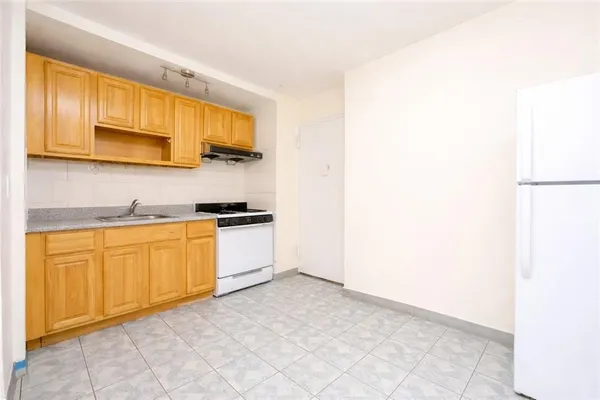 a kitchen with stainless steel appliances granite countertop a refrigerator and a stove top oven