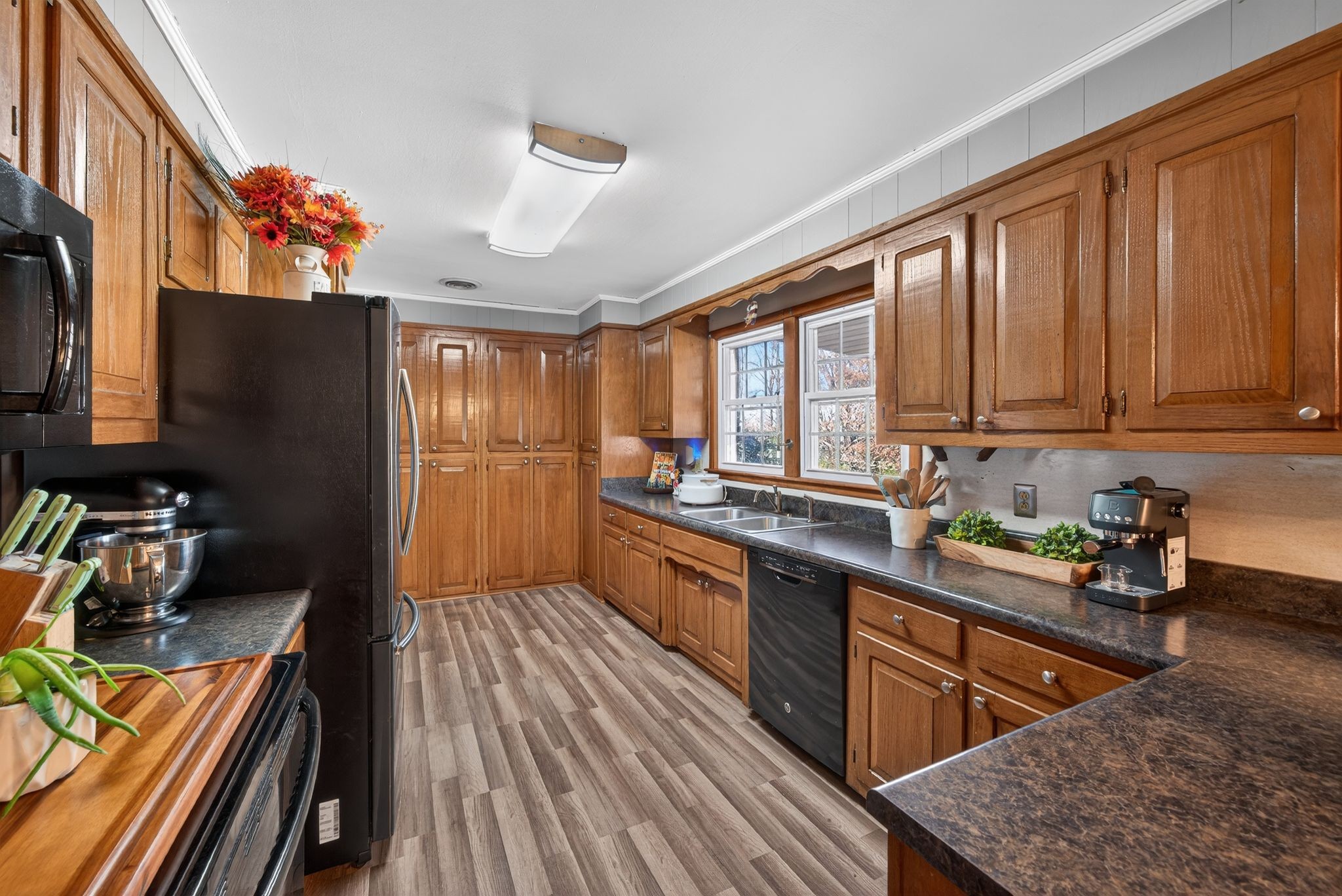 2191 Highway 100 Centerville, TN 37033 - Photo 3 of 11 a kitchen with stainless steel appliances granite countertop wooden cabinets a stove top oven a sink and dishwasher with wooden floor