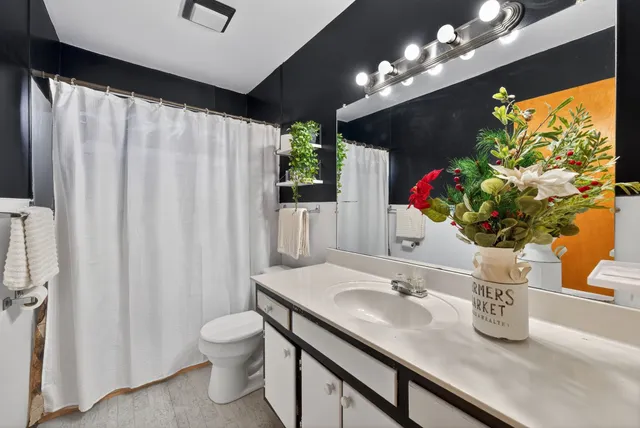 a bathroom with a sink a toilet and a mirror