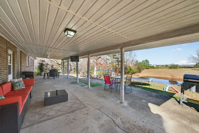 a view of swimming pool with lounge chairs in patio