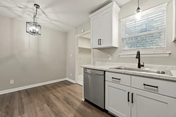 a kitchen with a sink cabinets and window