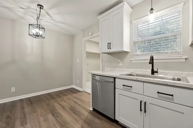 a kitchen with a sink cabinets and window