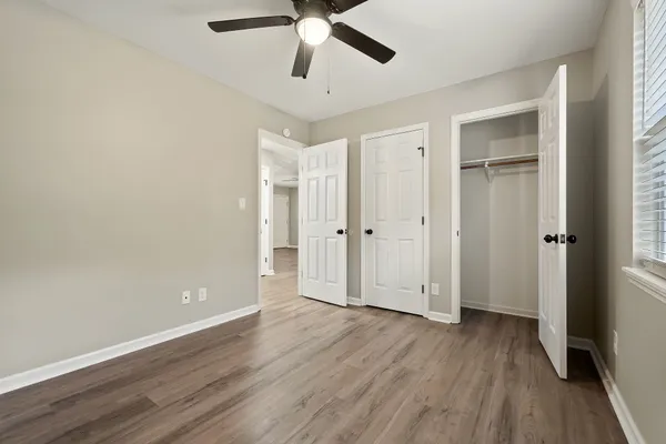a view of empty room with wooden floor