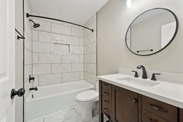 a bathroom with a sink a toilet and a mirror