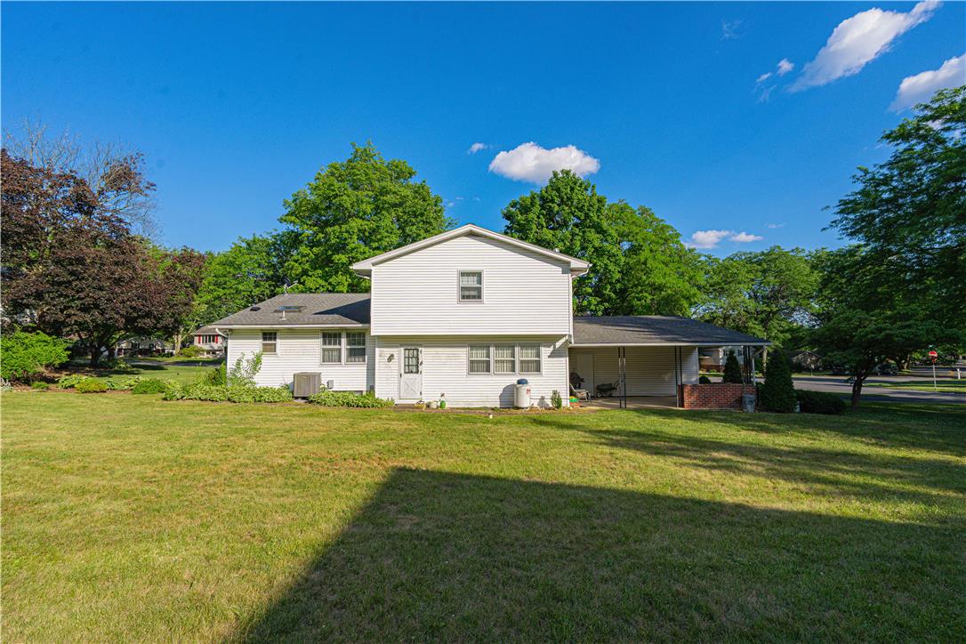 5425 Clauser Road Orefield, PA 18069 - Photo 12 of 18 A classic white-sided residence nestled amidst verdant trees and a vast lawn.