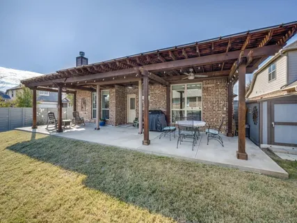 a view of a patio with table and chairs a barbeque with wooden fence