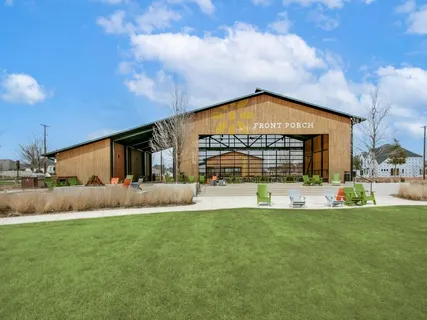 a front view of a house with a garden and yard