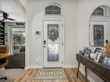a view of an entryway with wooden floor