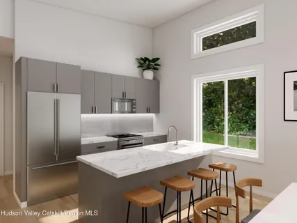 a kitchen with stainless steel appliances granite countertop a table chairs and a refrigerator