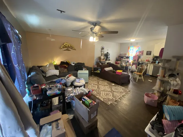 a living room with lots of furniture and gym equipment