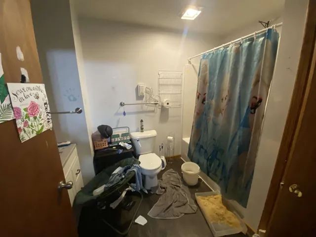 a bathroom with a sink mirror and toilet