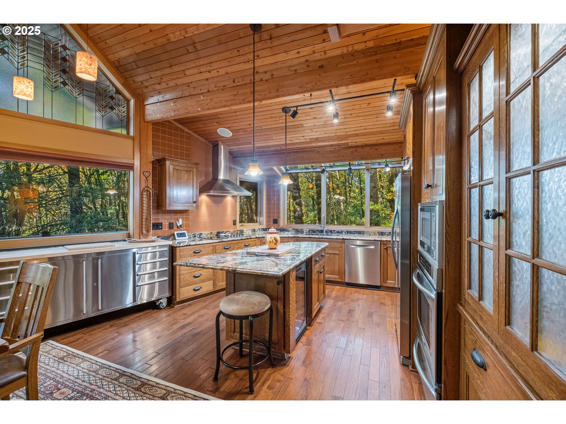 6894 Prospect Ridge Road South Salem, OR 97306 - Photo 13 of 48 a kitchen with a stove a refrigerator and wooden cabinets
