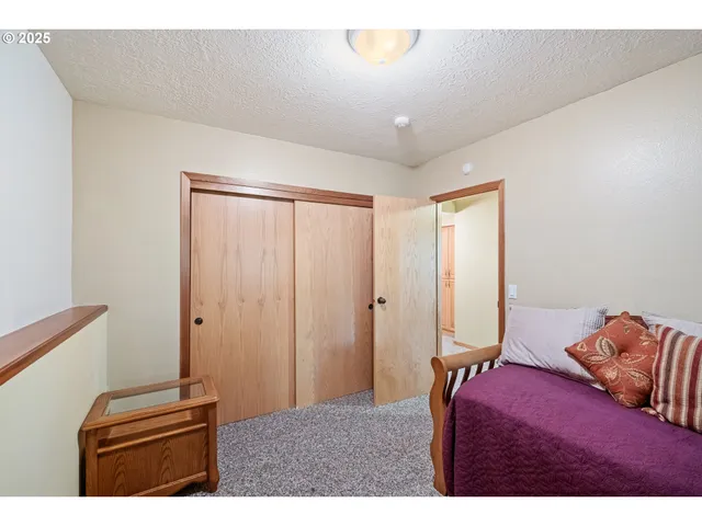 a bedroom with a bed and a large window